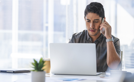 Man on laptop and phone