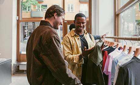Image of two men purchasing clothes