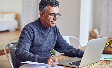 Man using his laptop and a phone